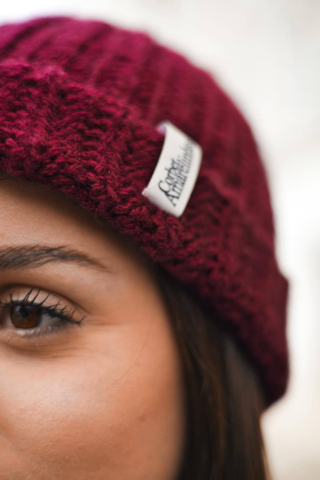 Close-up of designer Isabel Aires wearing a crochet beanie with Corbet x Amarelinhas beanie.