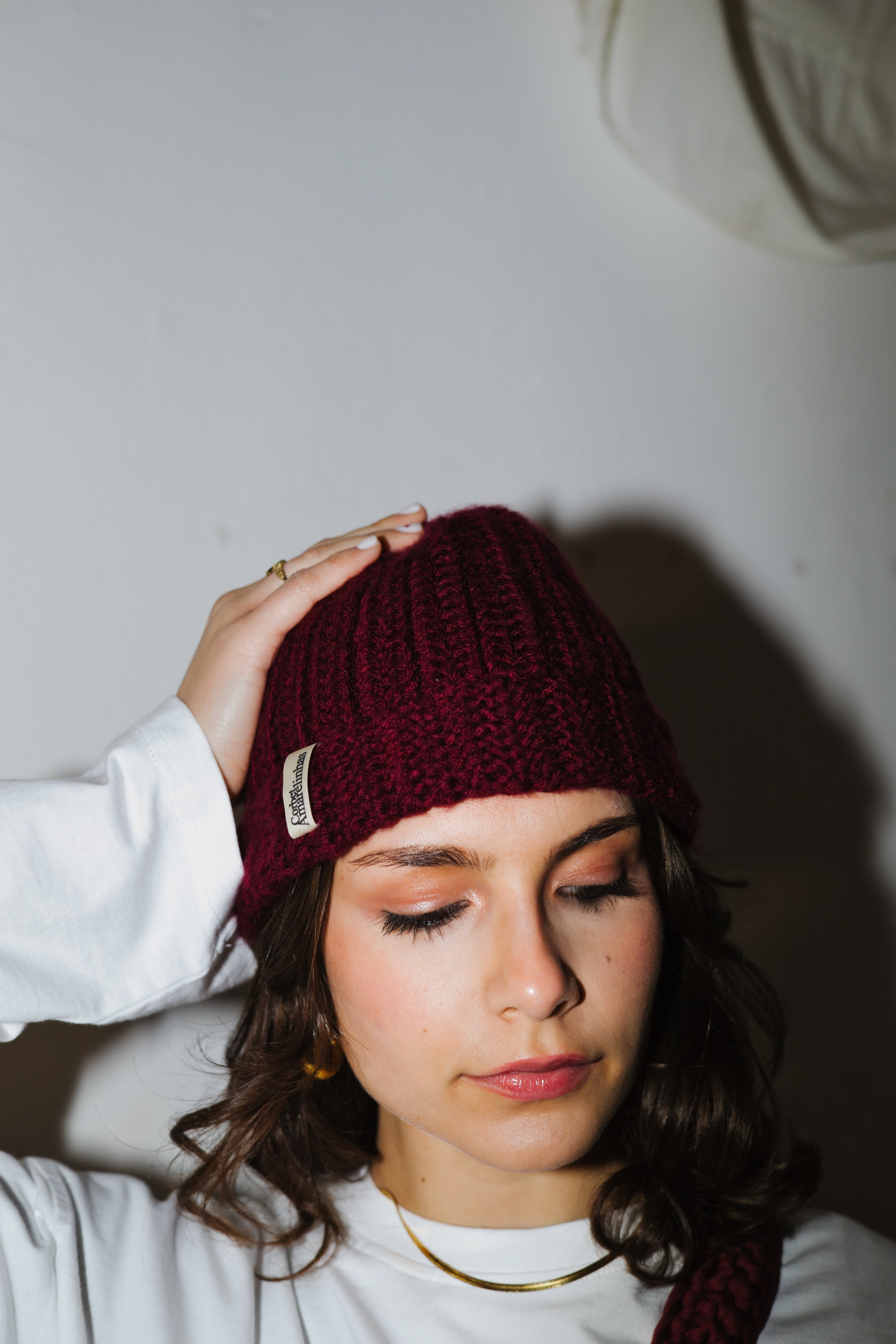 Girl wearing a handmade red wine crochet beanie